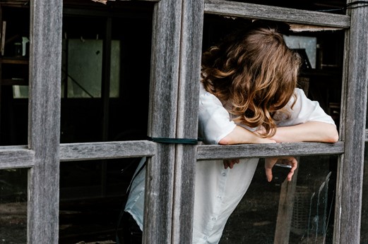 Woman at window depressed